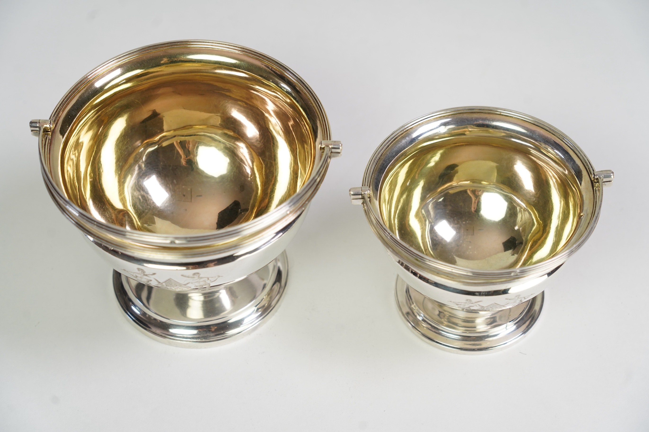 Two George III graduated silver pedestal sugar baskets, by James Darquits